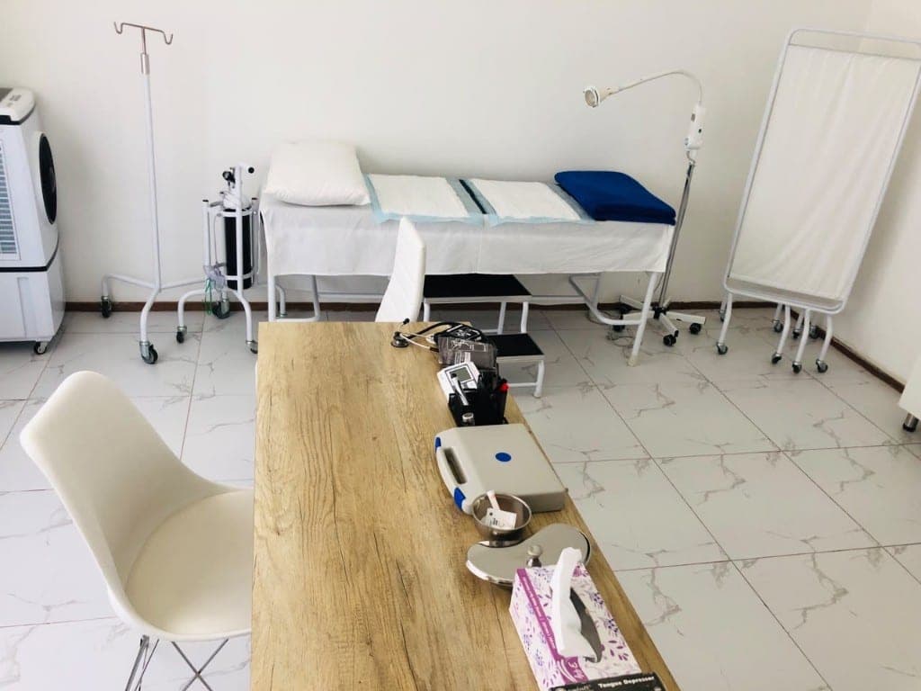 Consultation desk and examination bed inside Elshaddai Health Care Centre